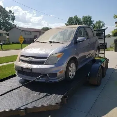 A car is sitting on top of a trailer.