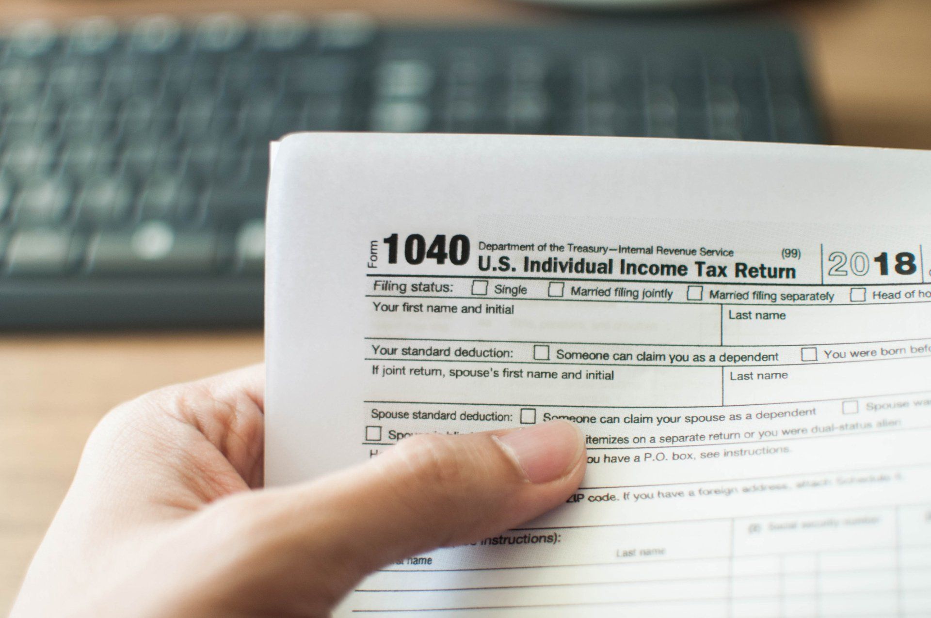 Holding a Tax Form — Billings, MT — Able Tax & Accounting
