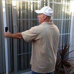 Man Installing Glass Door — Window Screens in Goleta, CA