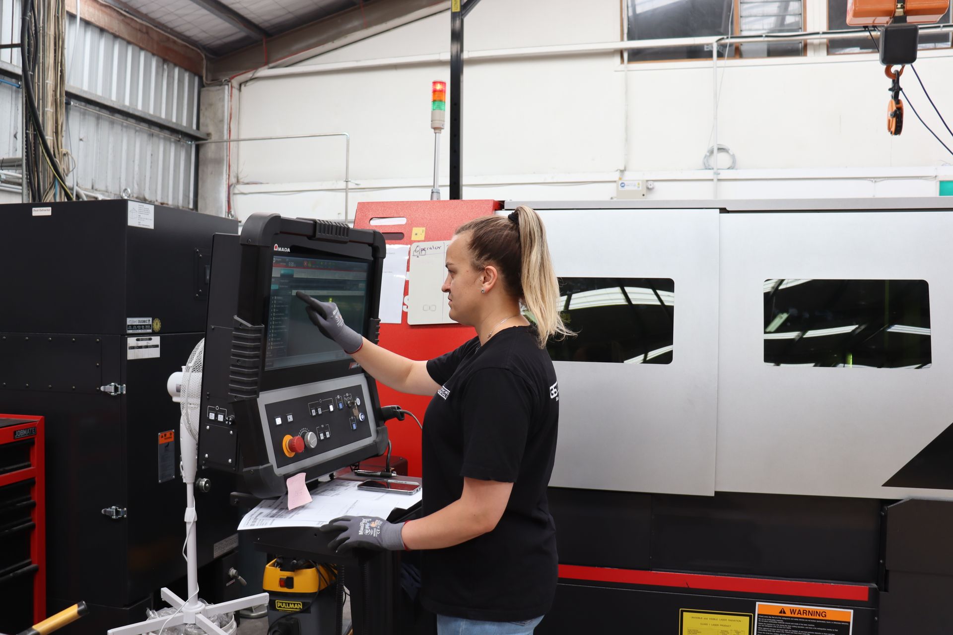A bunch of metal pipes are stacked on top of each other on a table.