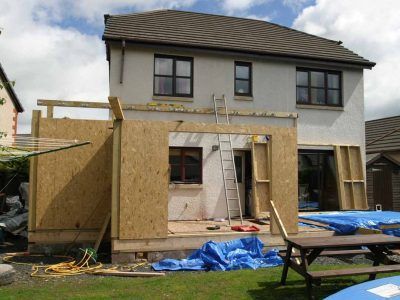 House extension under construction with exposed wood framing.