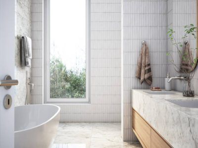 Modern bathroom with white tiling, a large window, marble countertop, and a soaking tub.