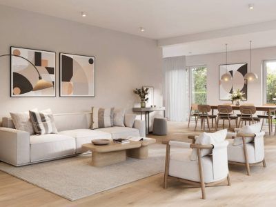 Modern living room with neutral colors, furniture, art, and open dining area.