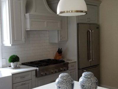 Kitchen with gray cabinets, stainless steel appliances, and white subway tile backsplash.
