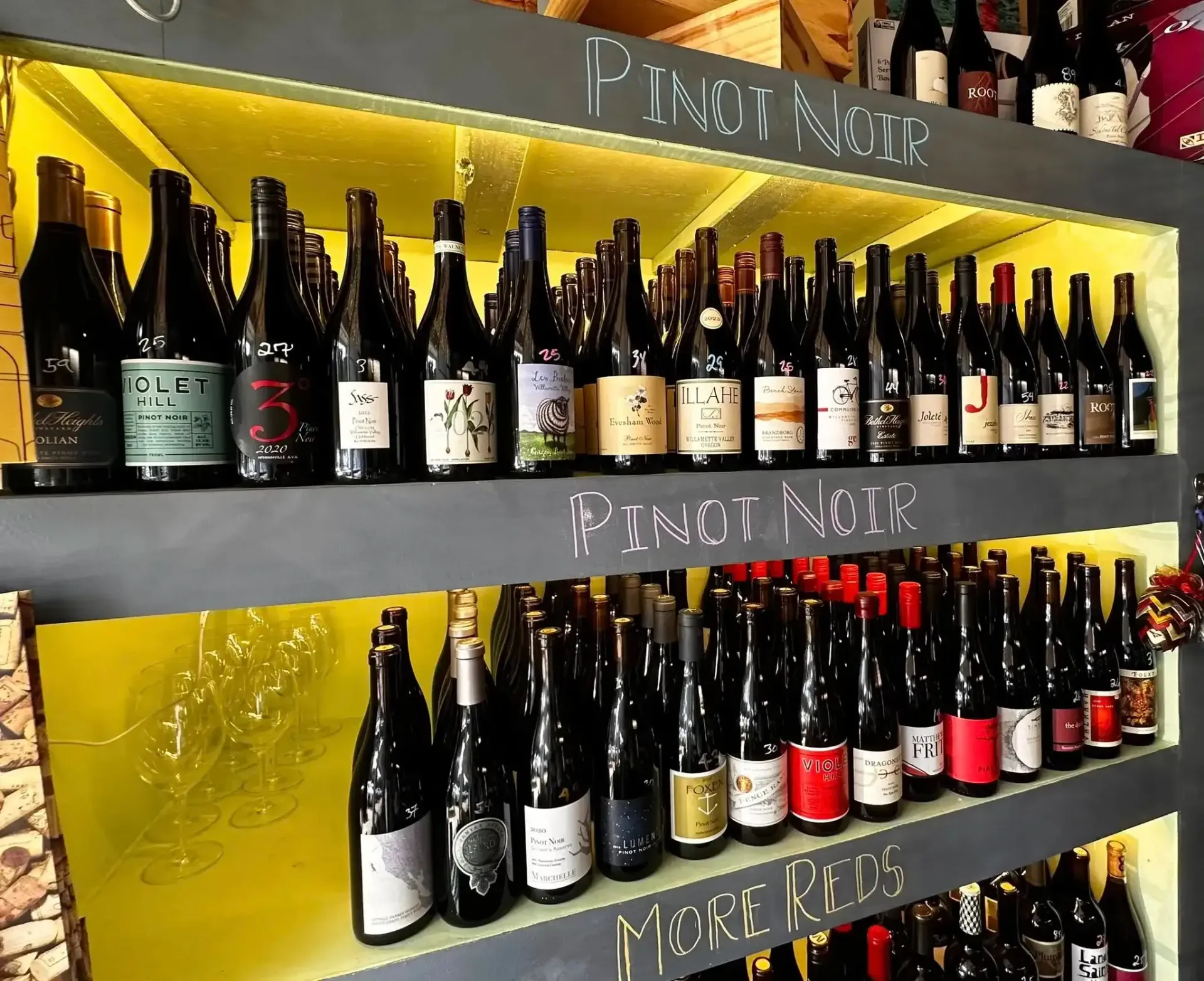 Wine bottles on shelves labeled