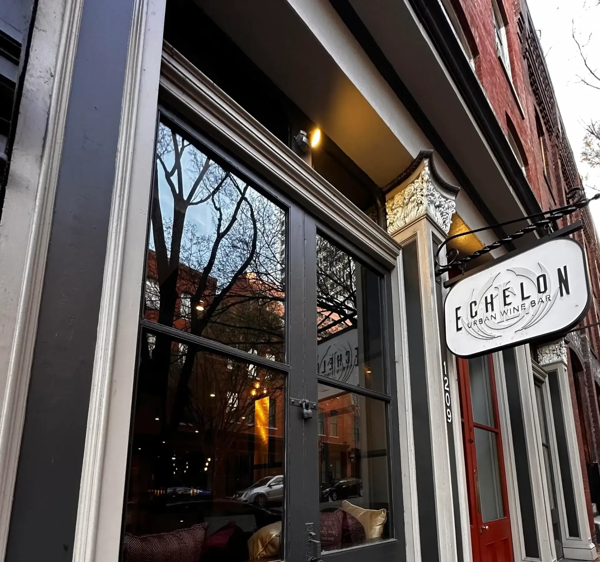 Close-up of champagne glass at a tasting, with place card, and handwritten notes on a table.