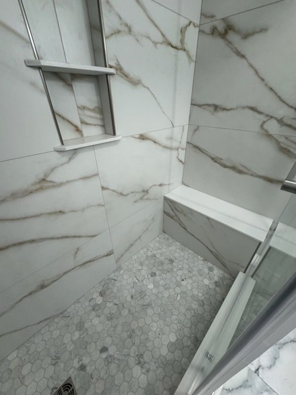 A bathroom with two sinks and a large mirror.
