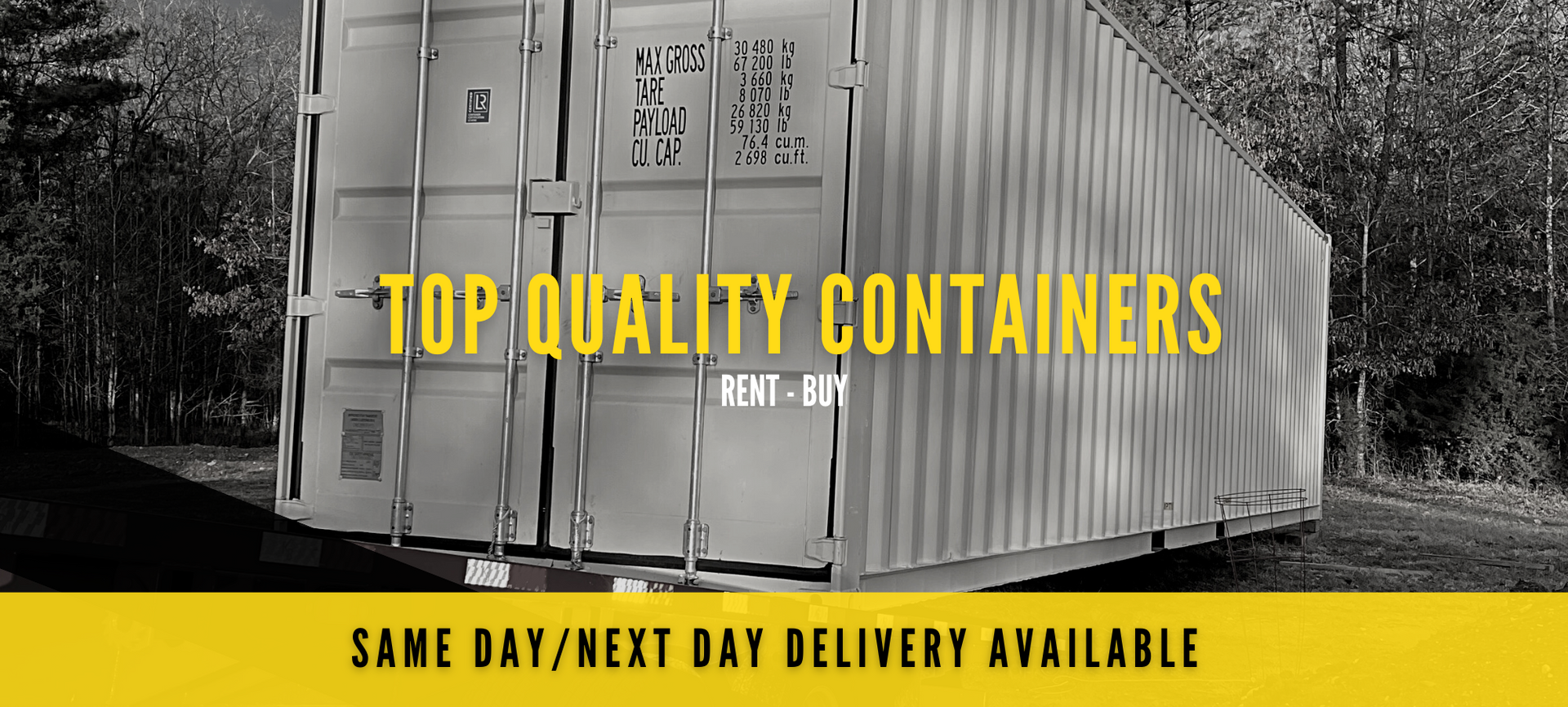 A black-and-white photo of a shipping container with yellow text: