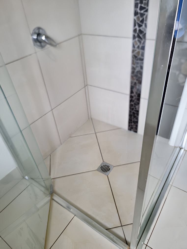 A Shower Stall With A Glass Door And Tiled Floor — A1 Cleaner Carpets N Homecare In Mareeba, QLD