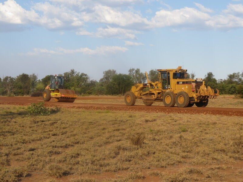 Bulldozer and Roller on a Rough Road — Earthmoving & Excavation Services in Rockhampton, QLD