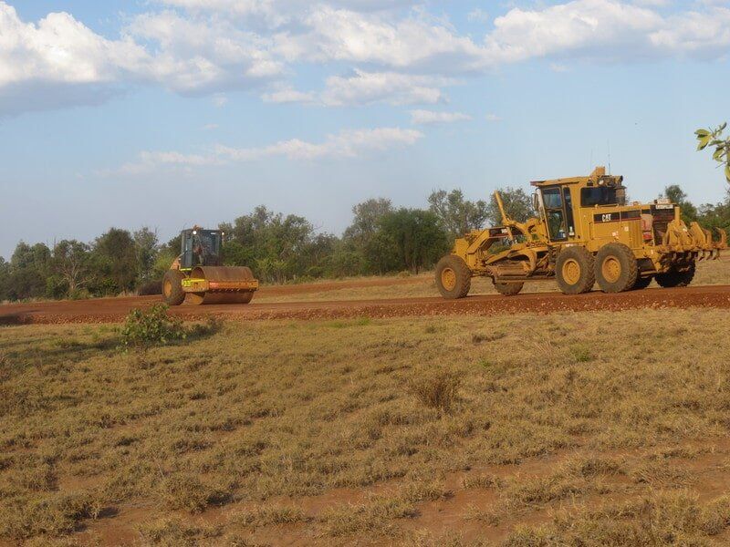 Bulldozer and Roller on a Rough Road — Earthmoving & Excavation Services in Rockhampton, QLD