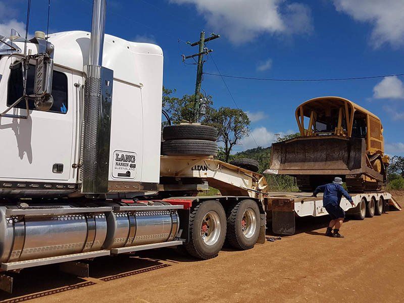 Truck Unloading the Excavator — Earthmoving & Excavation Services in Rockhampton, QLD