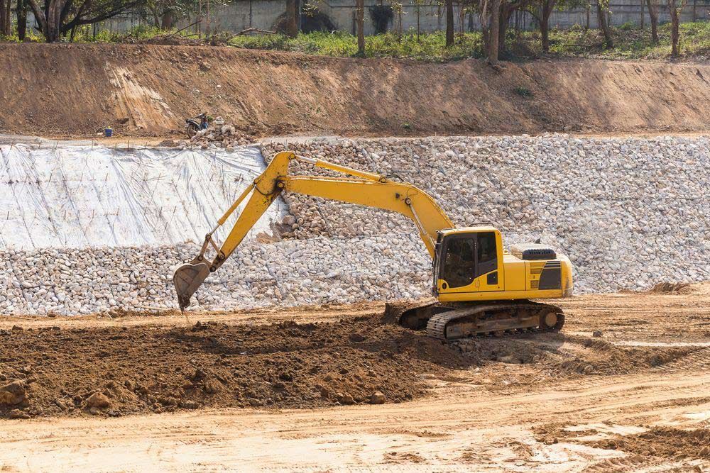 Yellow Excavator On Site For Dam Construction