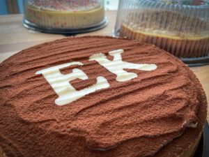 A close up of a cake with the letter e on it.