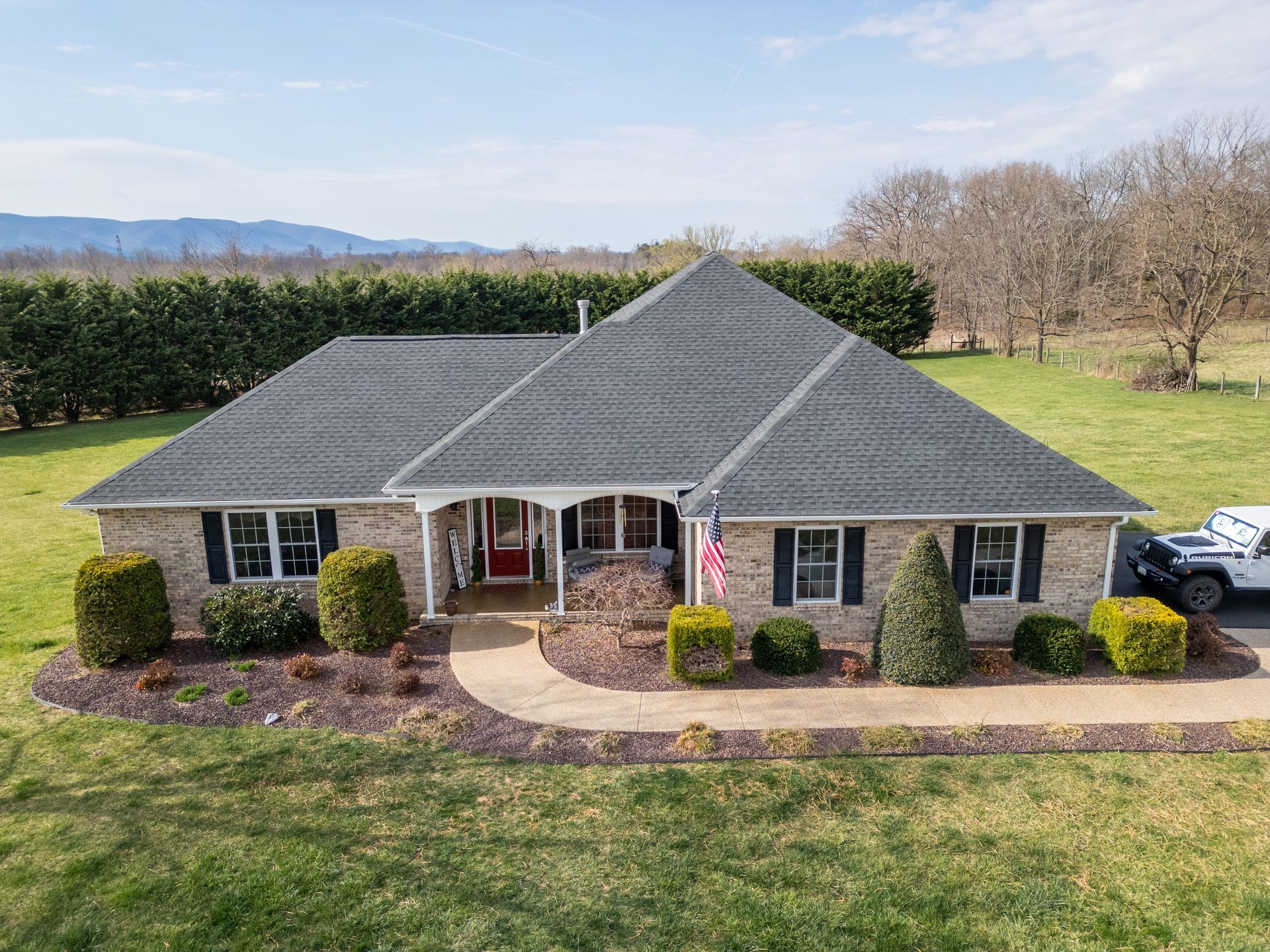 An aerial view of a house with a truck parked in front of it.
