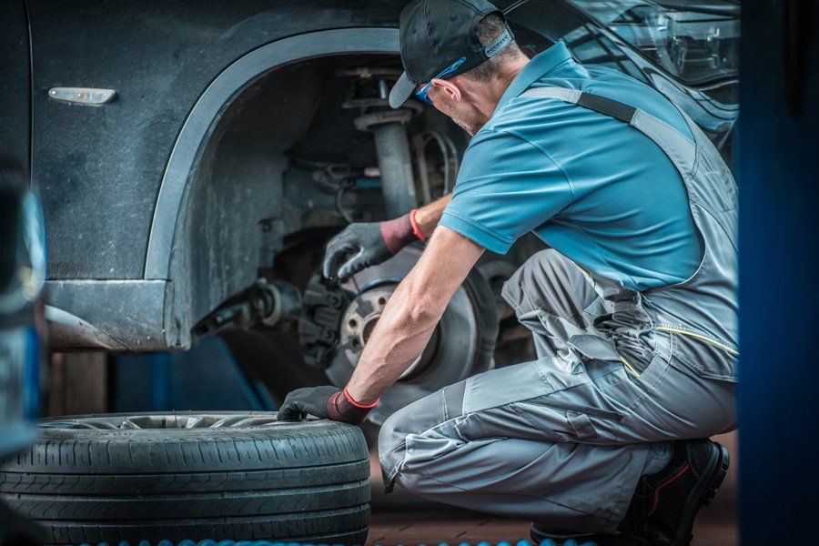 Man Replacing Car Tire — Greer, SC — Henson Auto Service