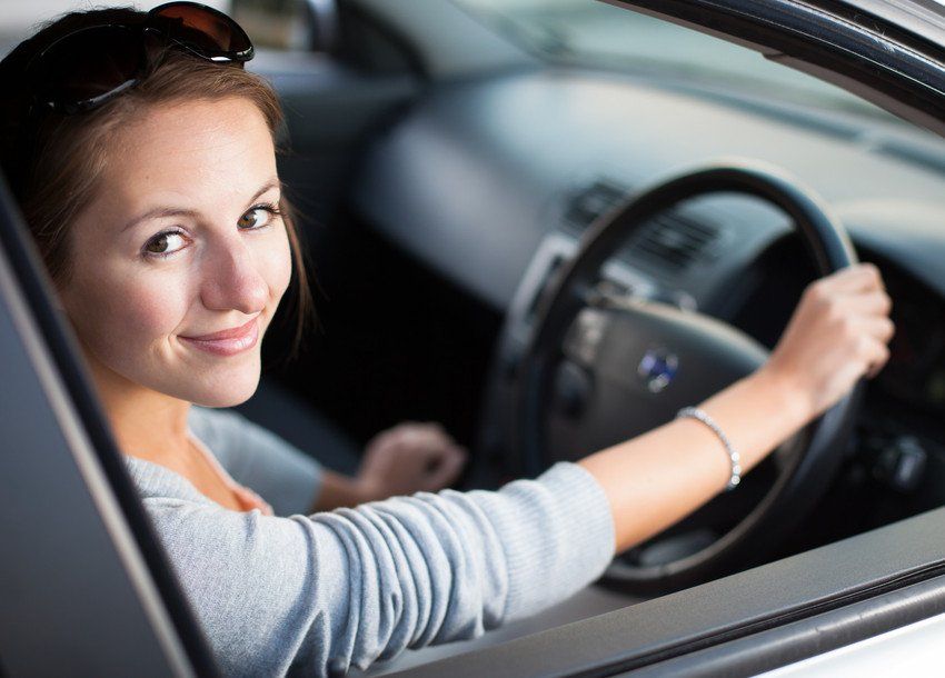 women smiling while driving a car