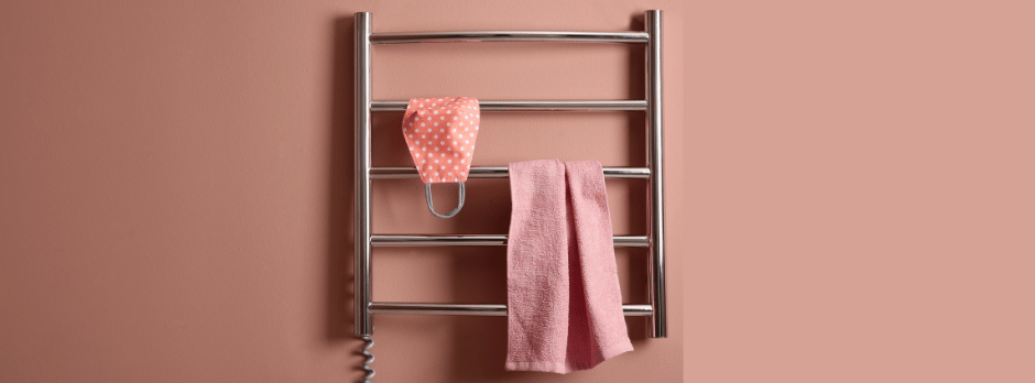 A towel rack with a pink towel hanging from it.