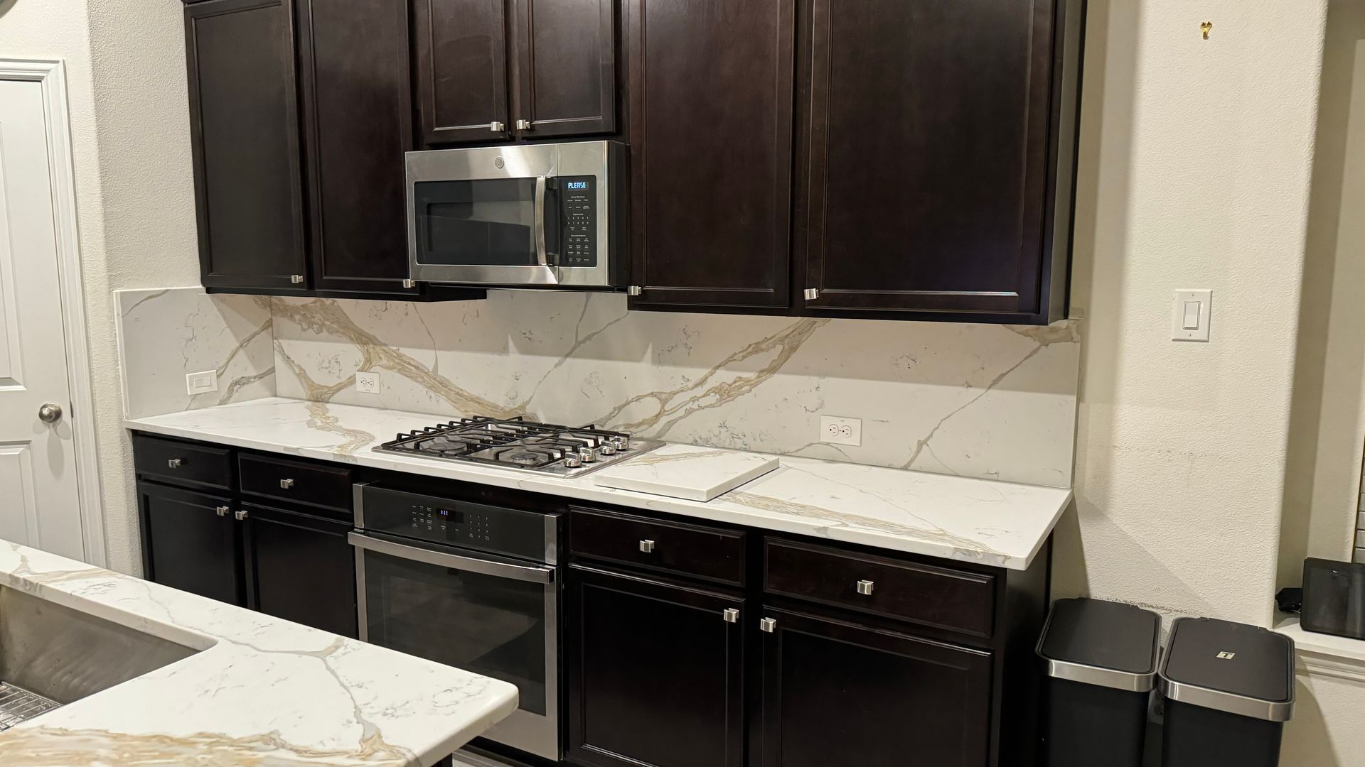 Quartz kitchen countertops with matching backsplash 