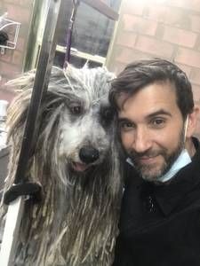 A man is taking a selfie with a dog.