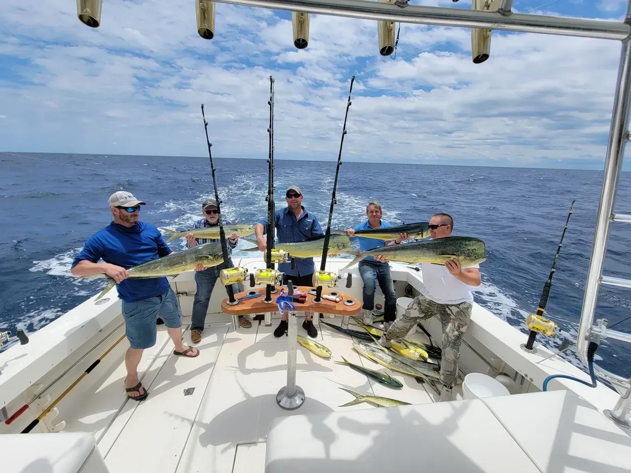 A bunch of fish are sitting on a wooden deck