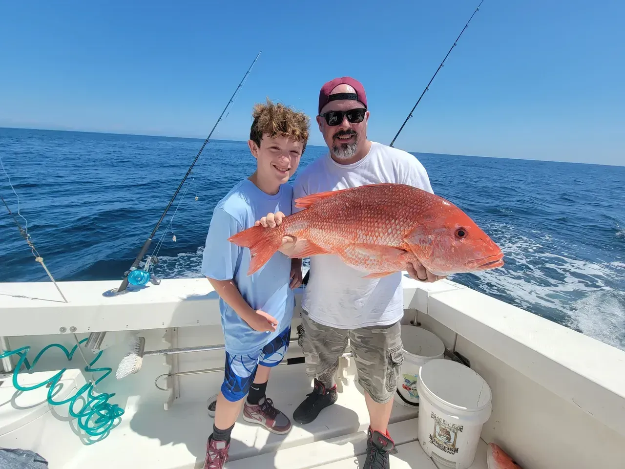 A bunch of fish are sitting on a wooden deck