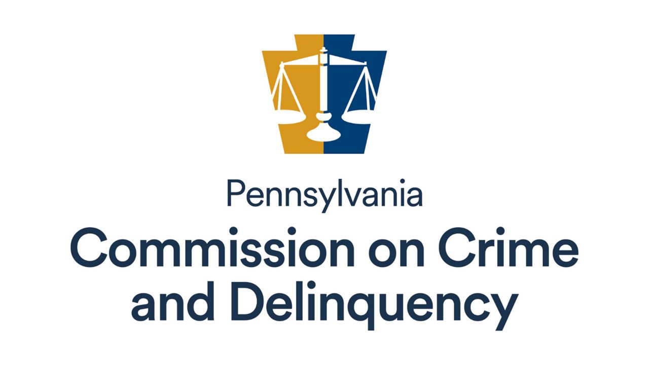 Pennsylvania Commission on Crime and Delinquency logo: Scales of justice in a blue and yellow keystone shape.