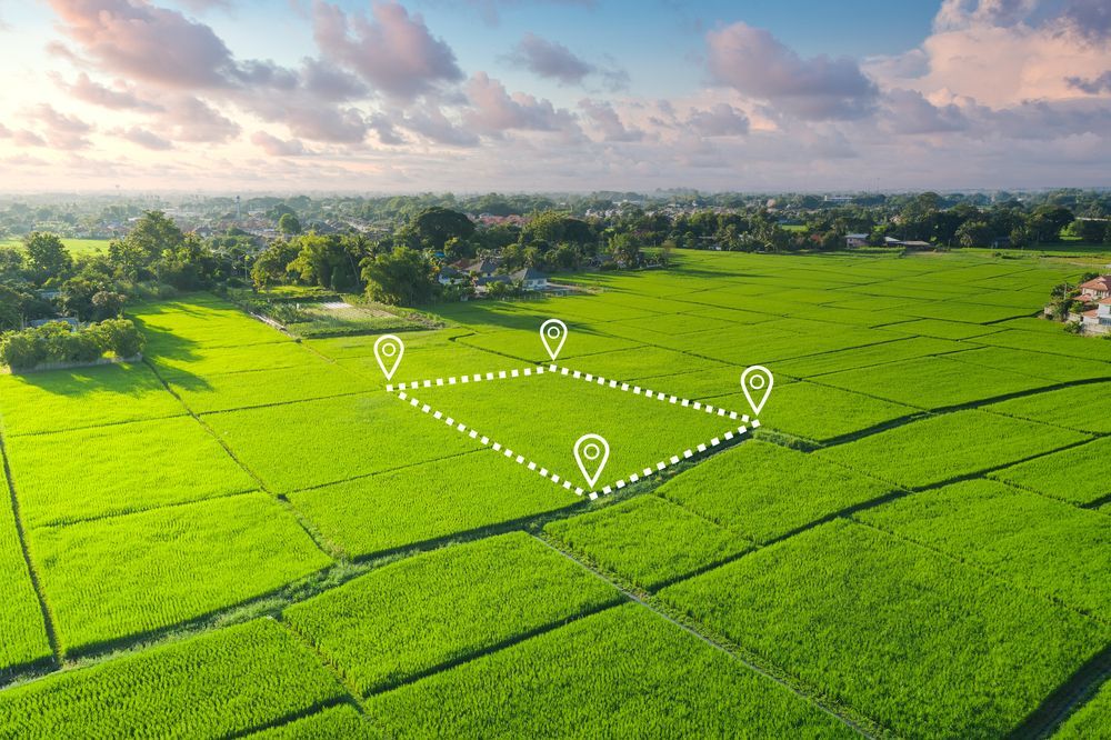 An aerial view of a lush green field with markers on it.