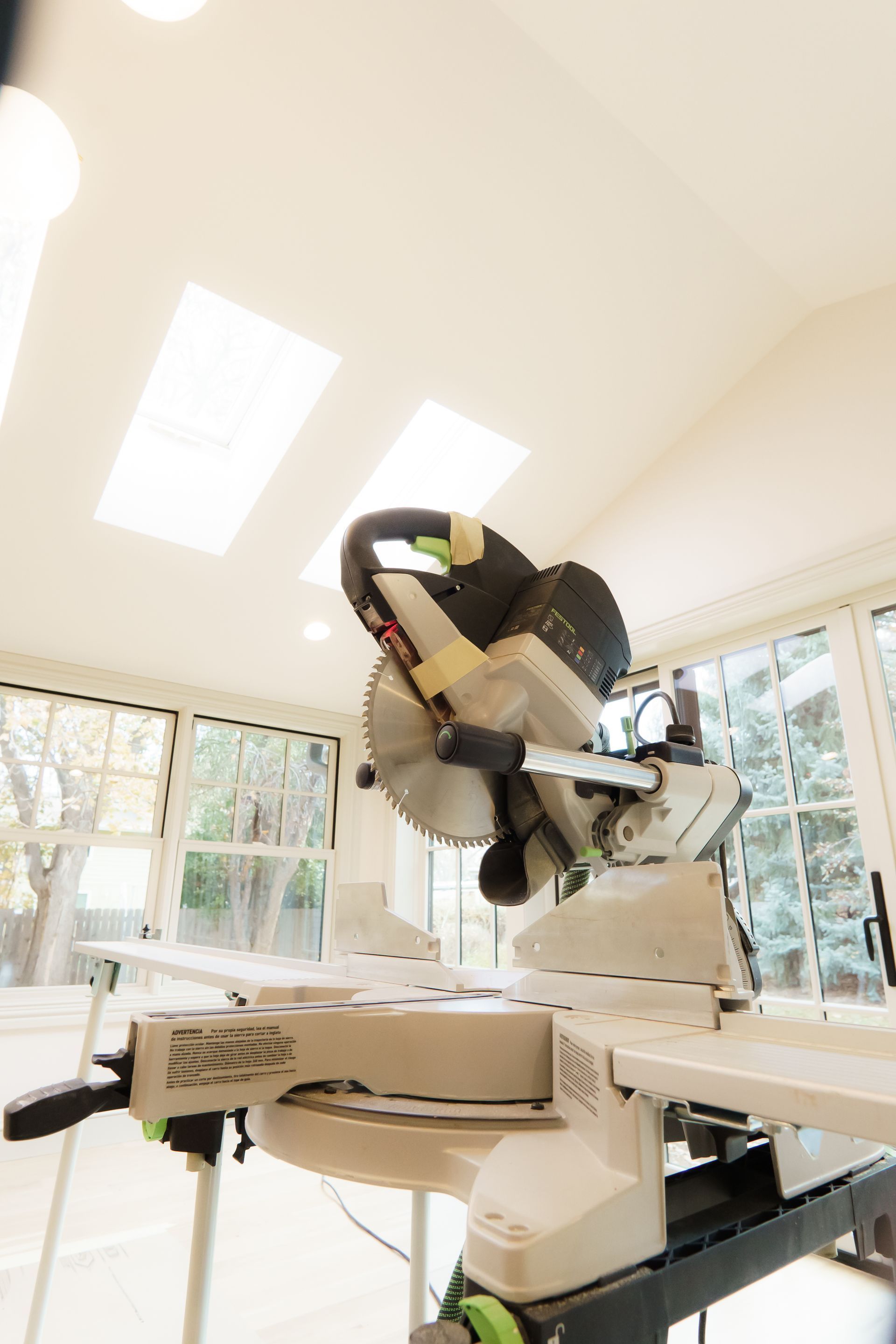 A circular saw is sitting on top of a table in a room.