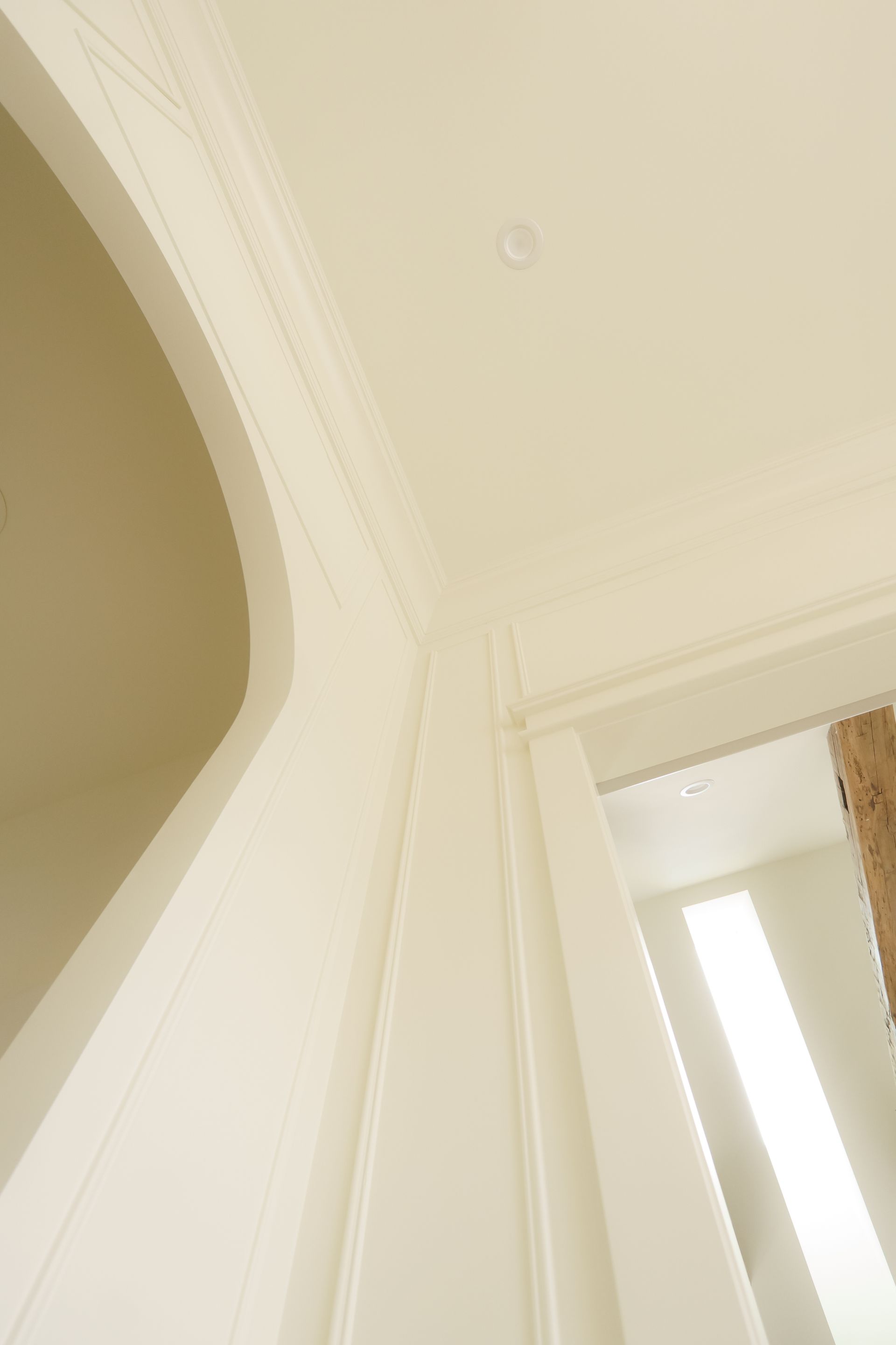 Looking up at the ceiling of a room with white trim.