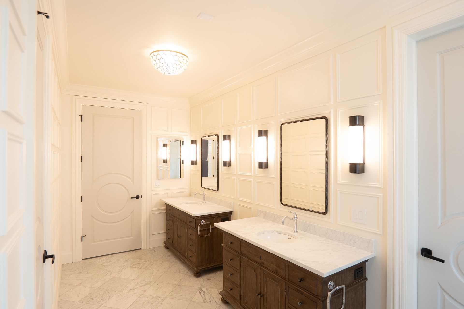 A bathroom with two sinks and two mirrors.