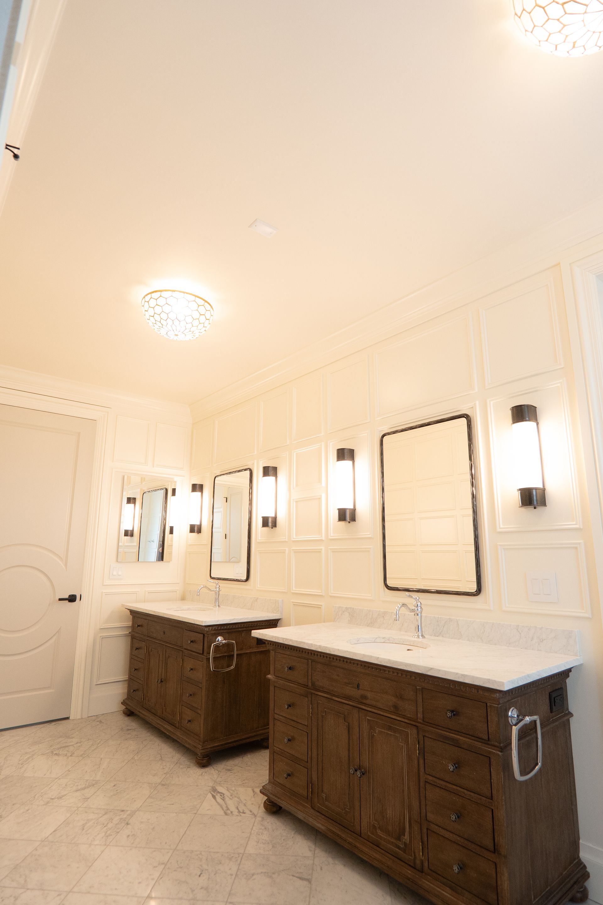 A bathroom with two sinks and two mirrors.