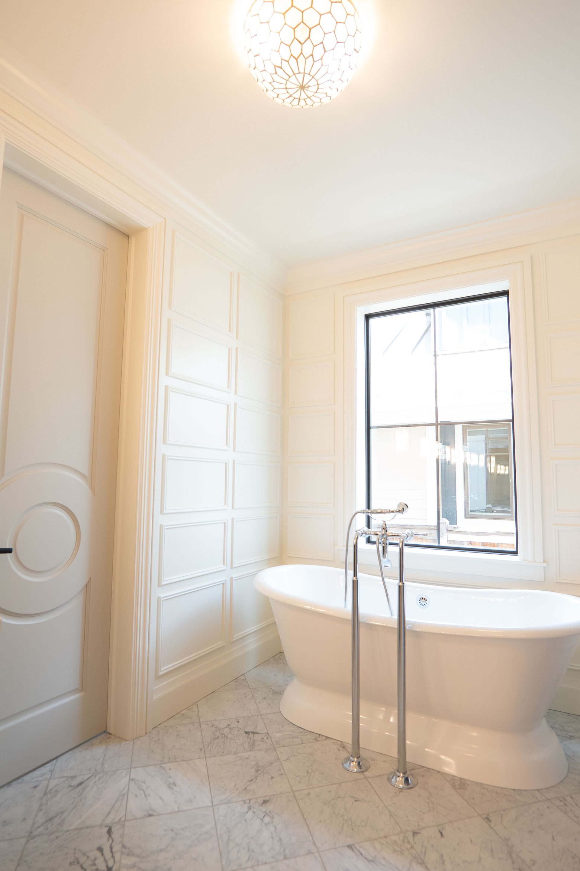 A bathroom with a tub and a window.