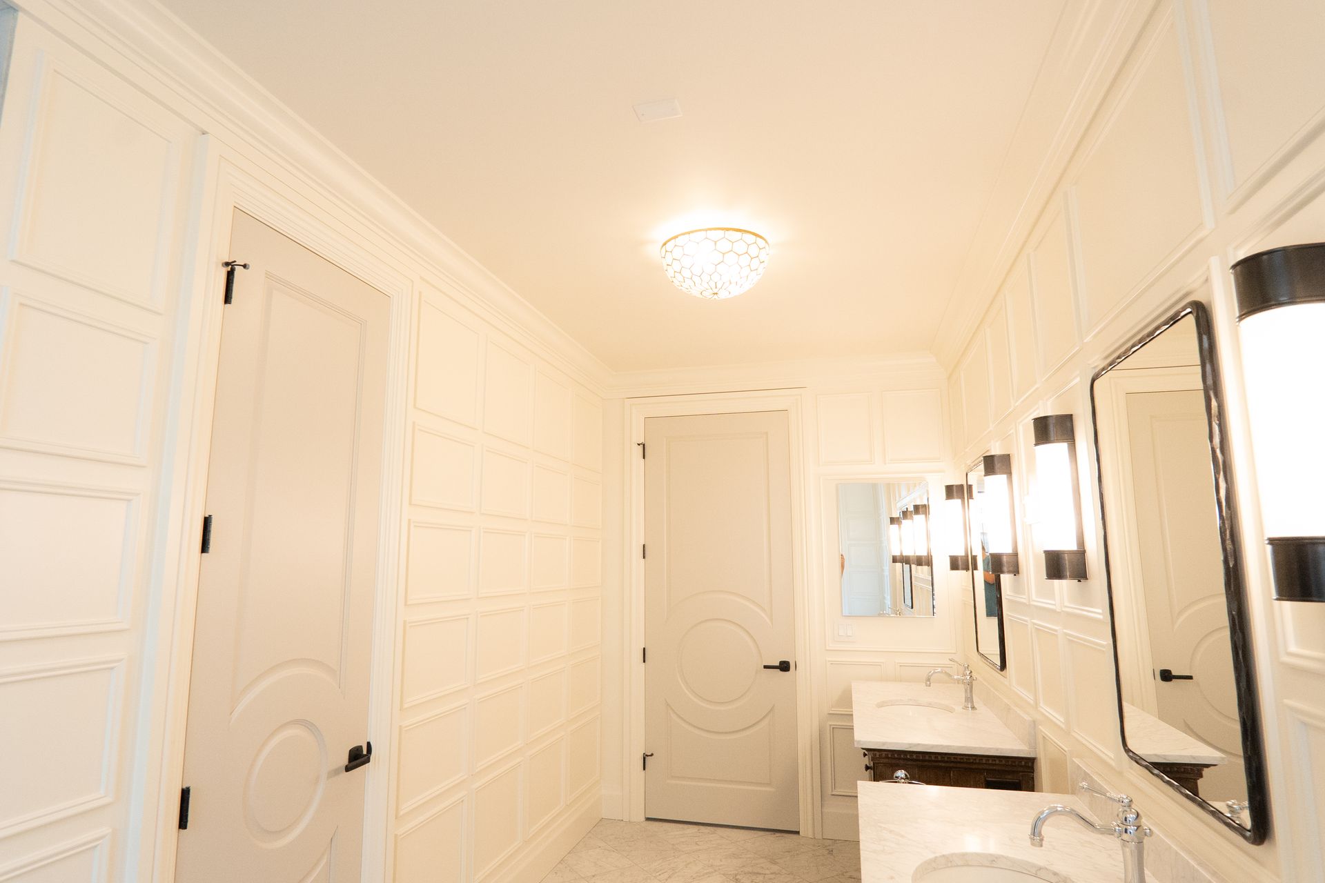 A bathroom with two sinks and two mirrors.