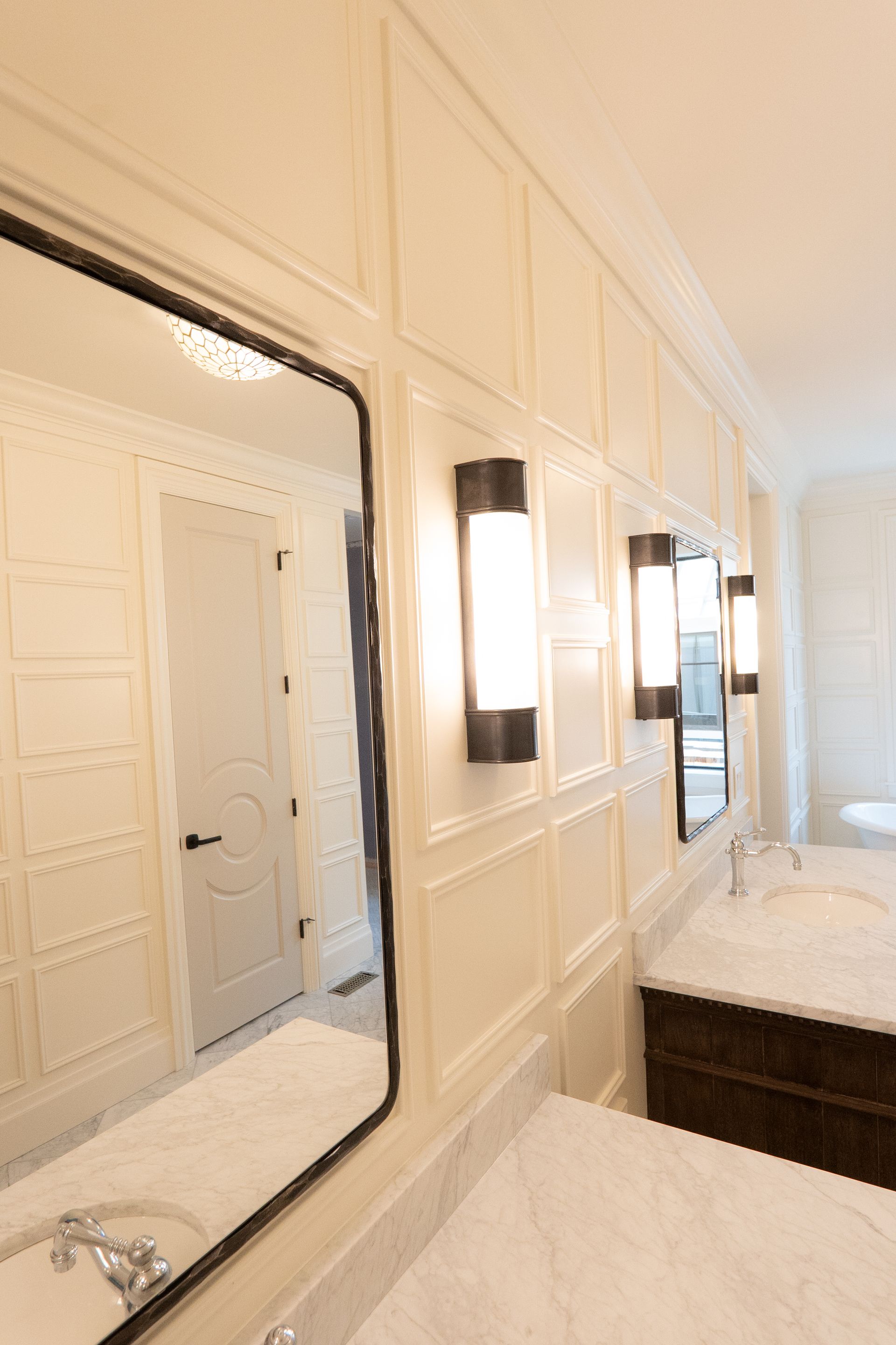 A bathroom with two sinks and a large mirror