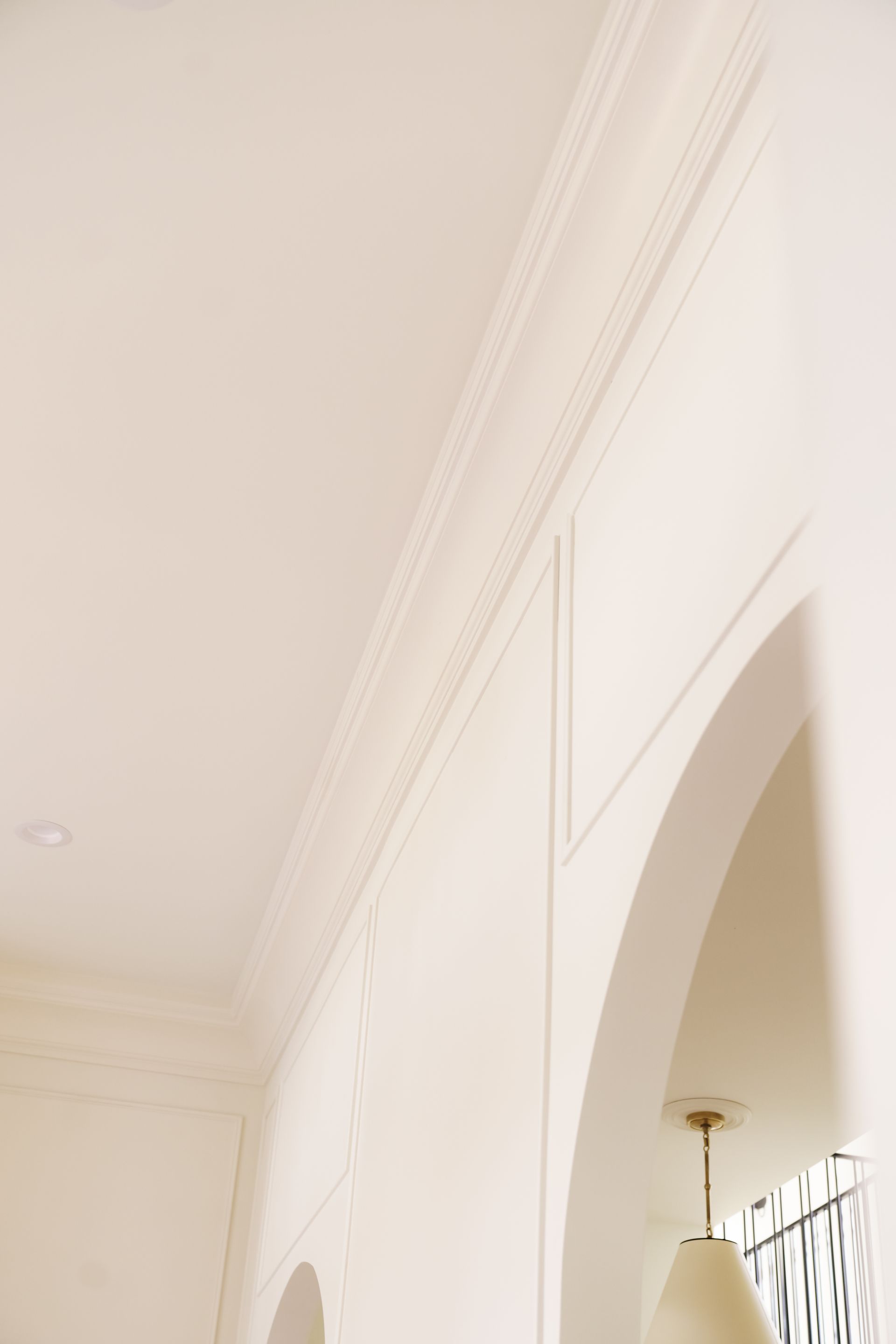 There is a lamp hanging from the ceiling in the room.