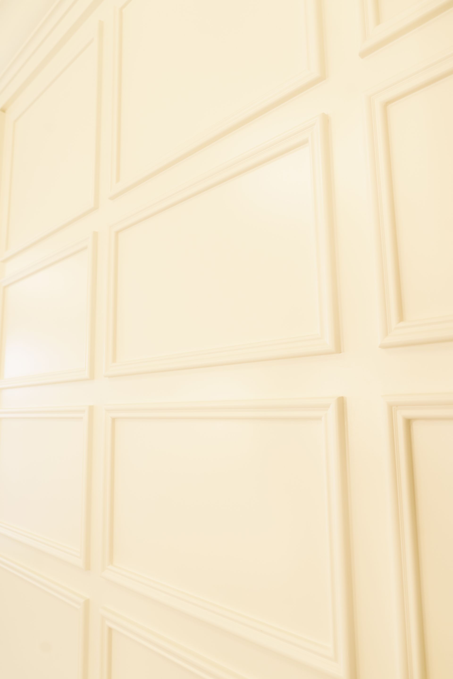 A close up of a white wall with a lot of squares on it.