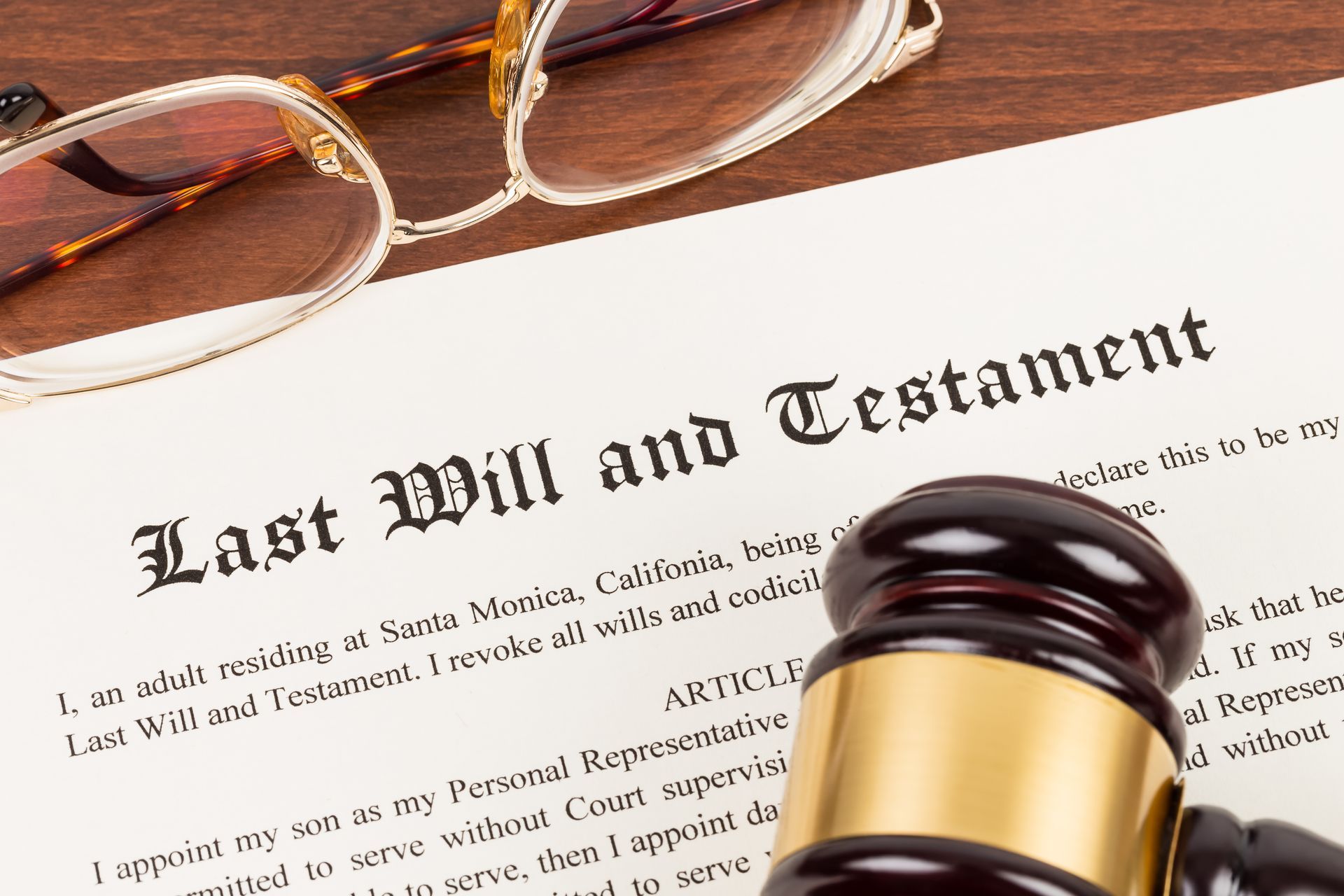 A pair of glasses is sitting on top of a last will and testament.