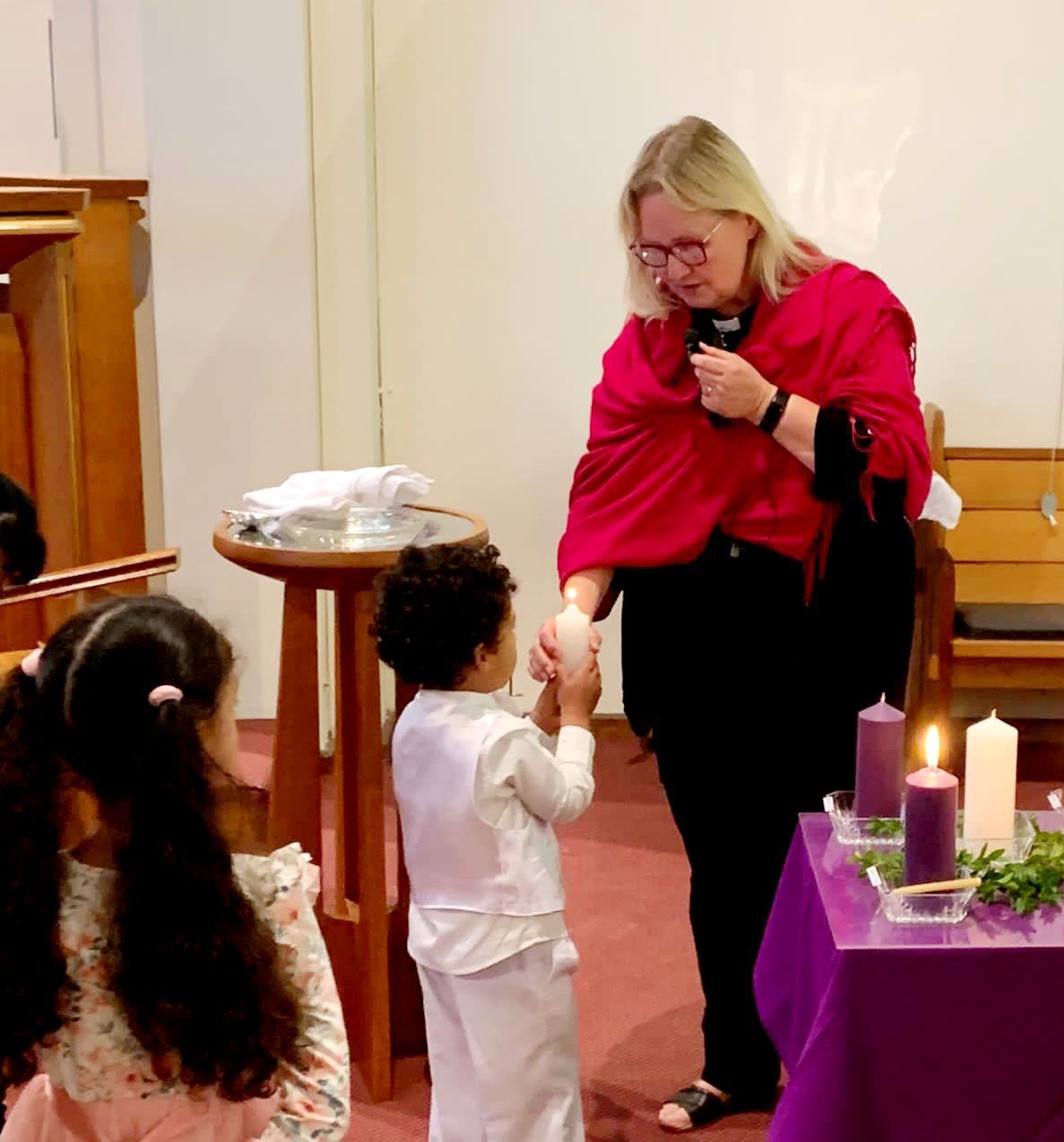 Child receiving baptism candle