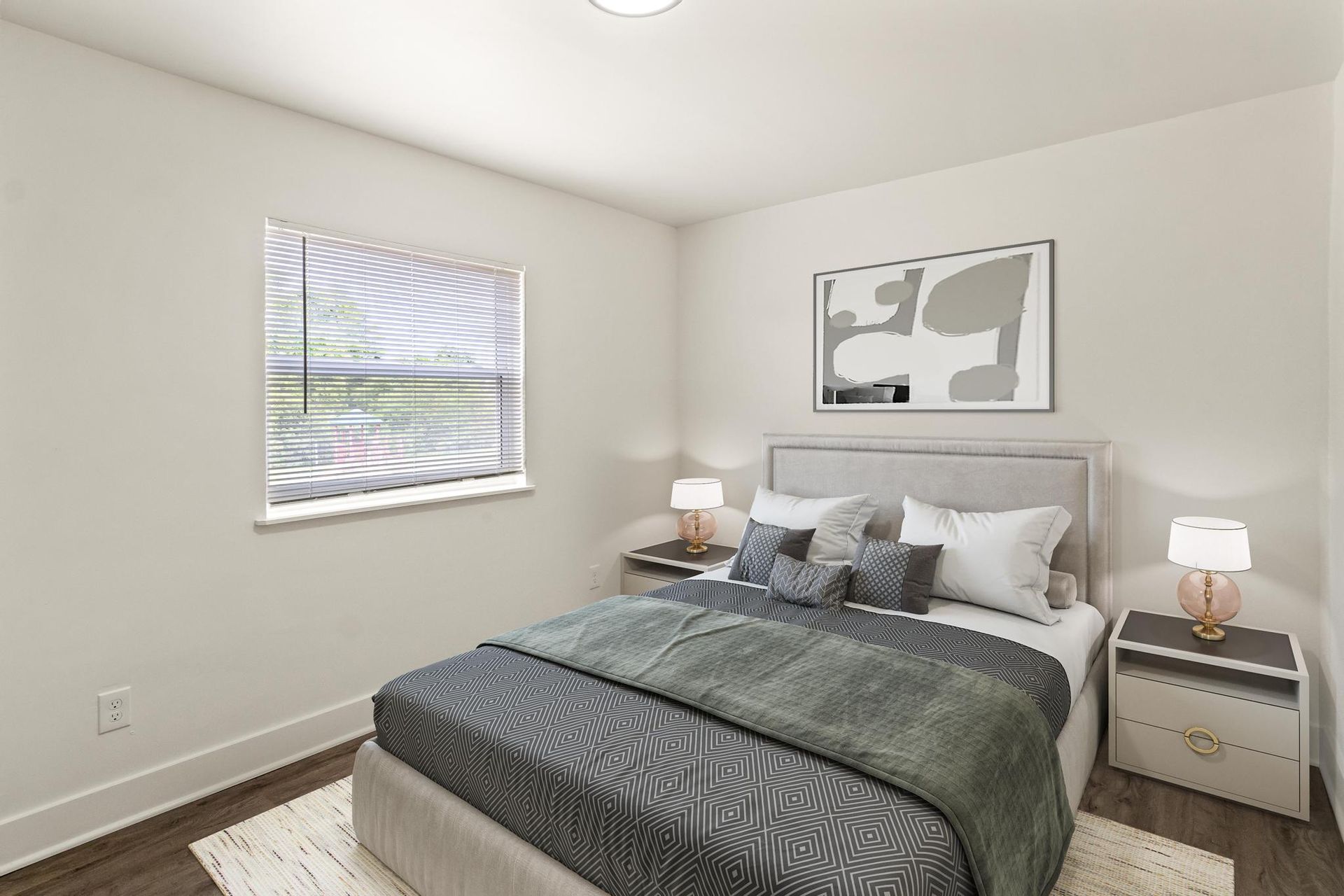 A bedroom with a bed , nightstands , lamps and a window.