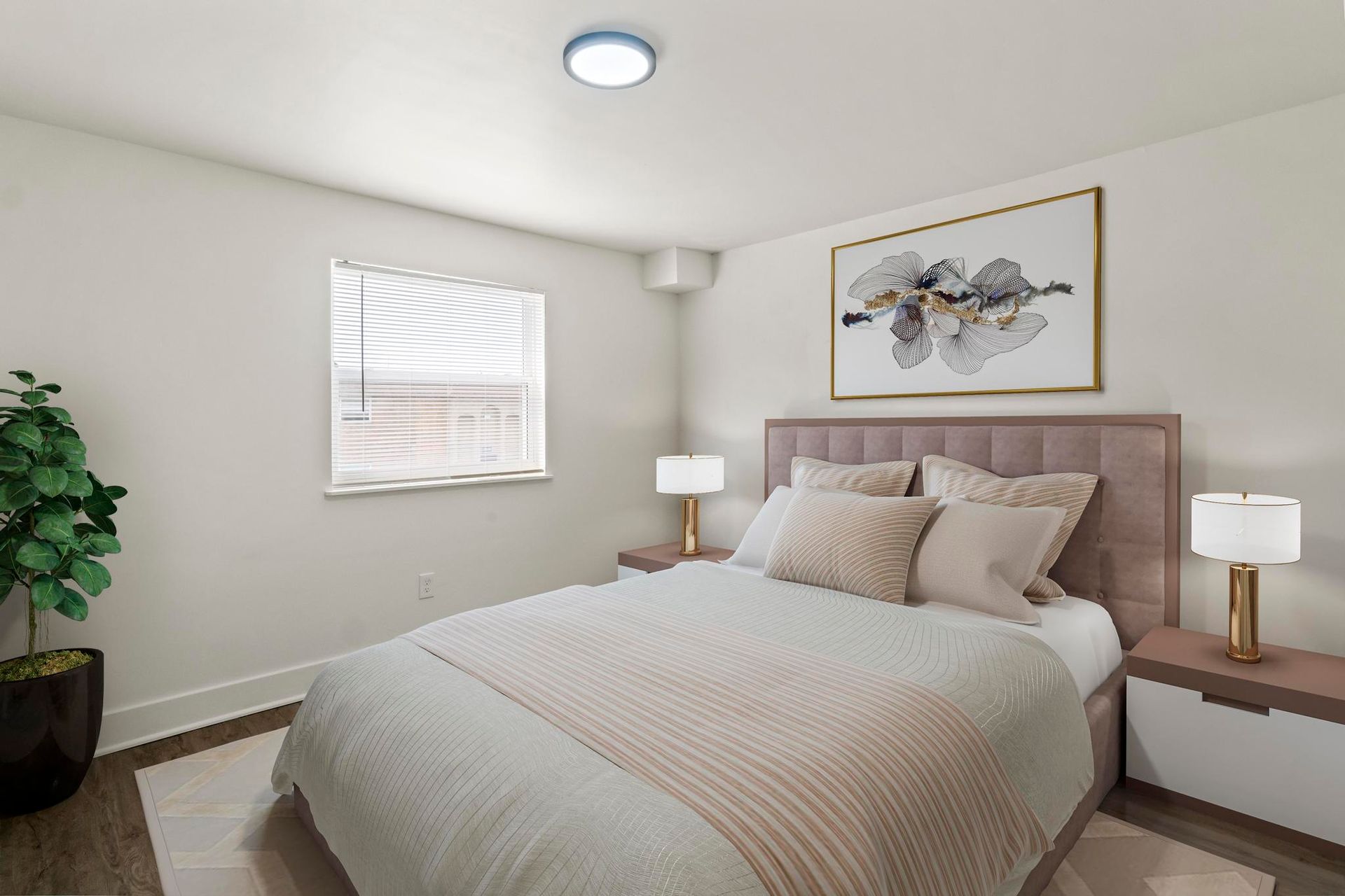 A bedroom with a bed , nightstands , lamps and a window.
