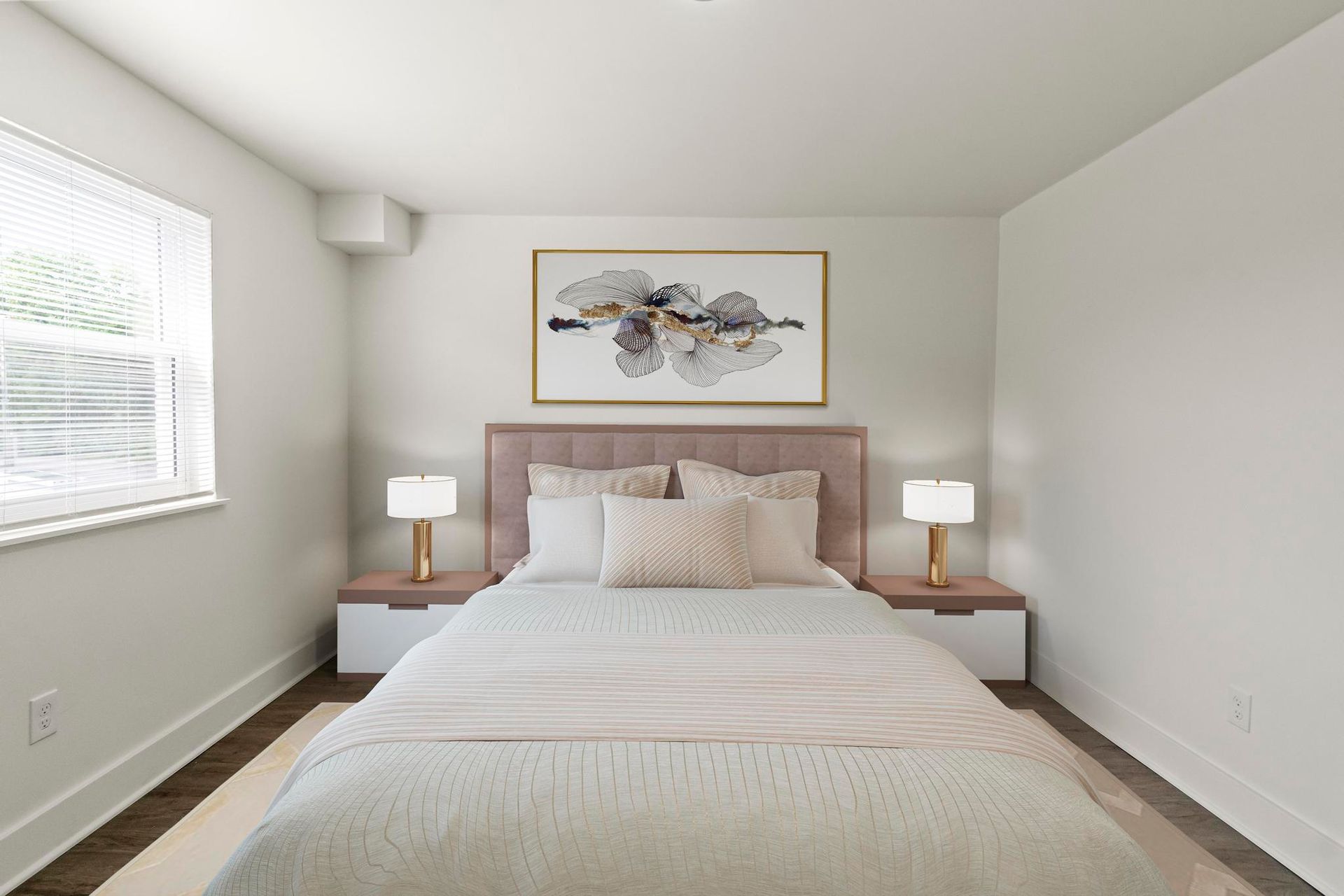 A bedroom with a bed , nightstands , lamps and a painting on the wall.