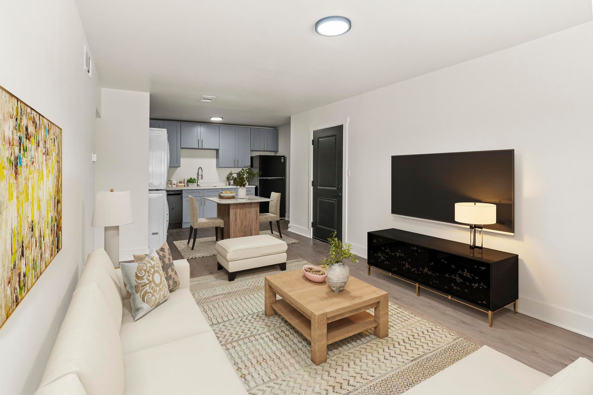 A living room with a couch , coffee table , and television.