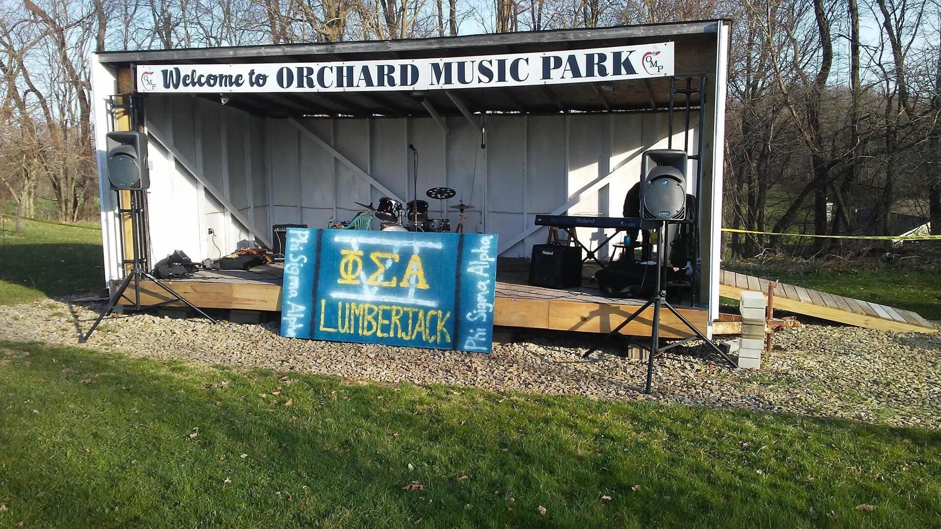 A stage with a sign that says welcome to orchard music park