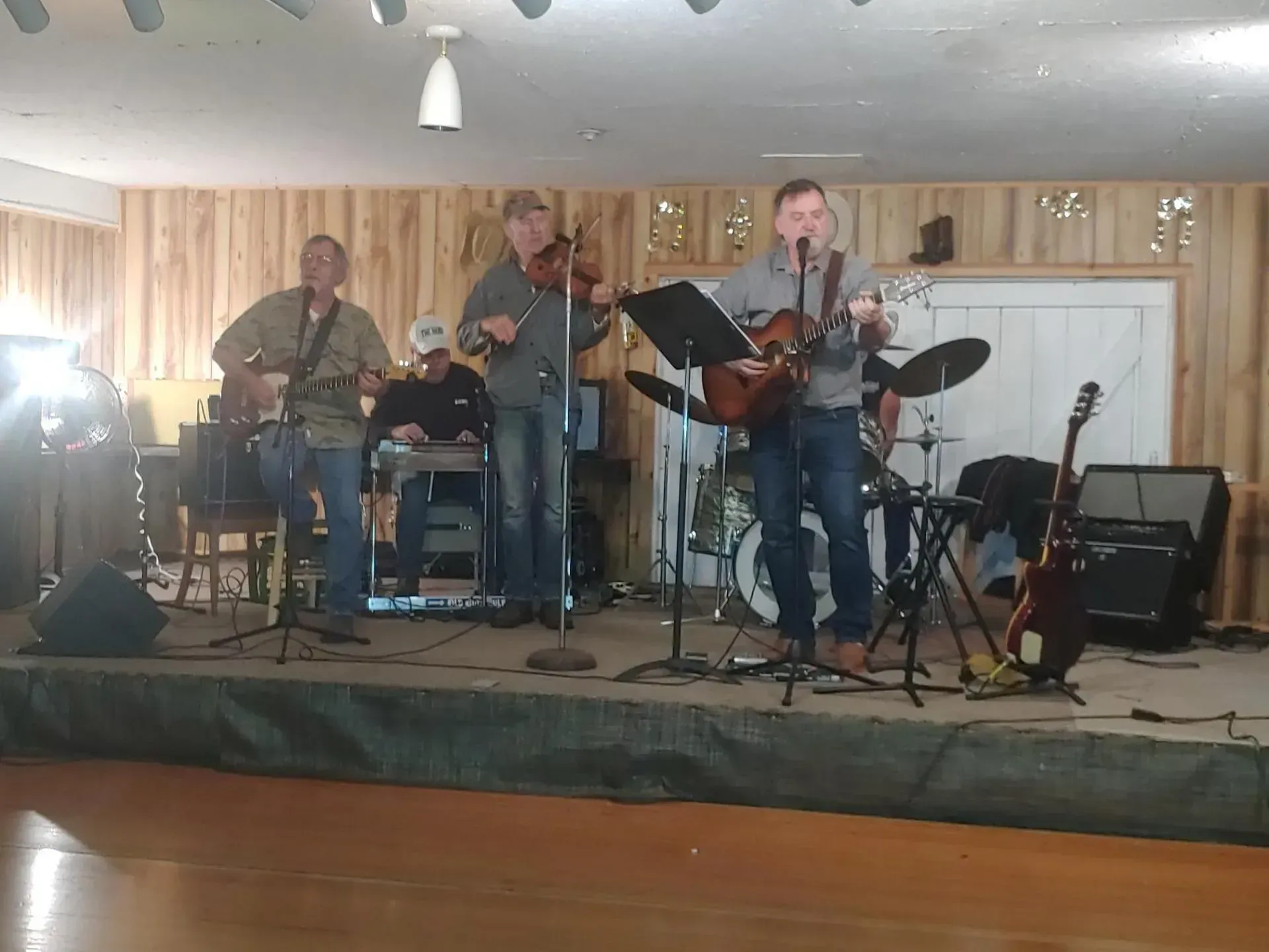 A group of men are playing instruments on a stage.