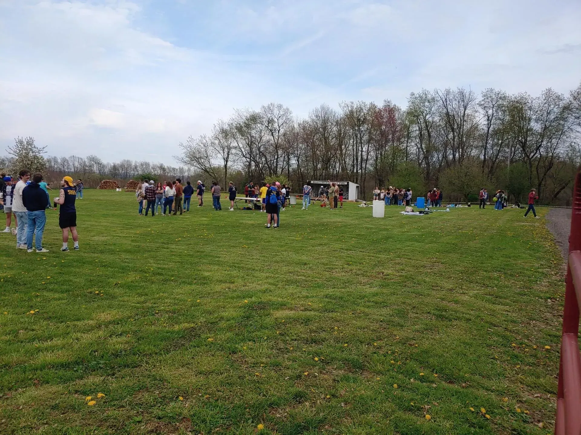 A group of people are standing in a grassy field.
