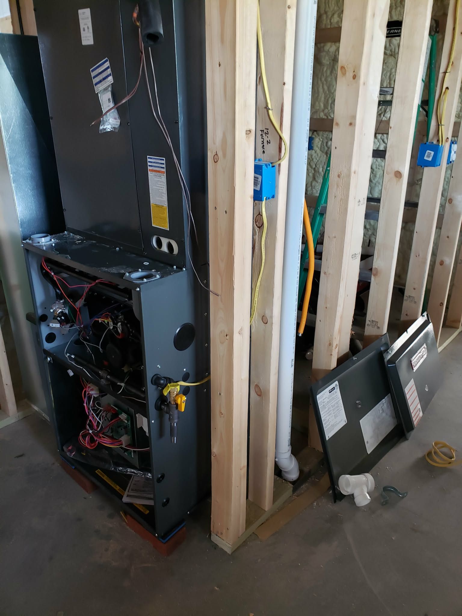 A wooden fence is sitting on top of a lush green field.
