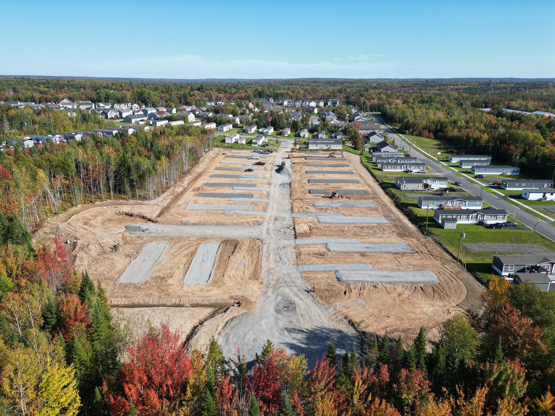 An aerial view of a construction site in the middle of a forest.