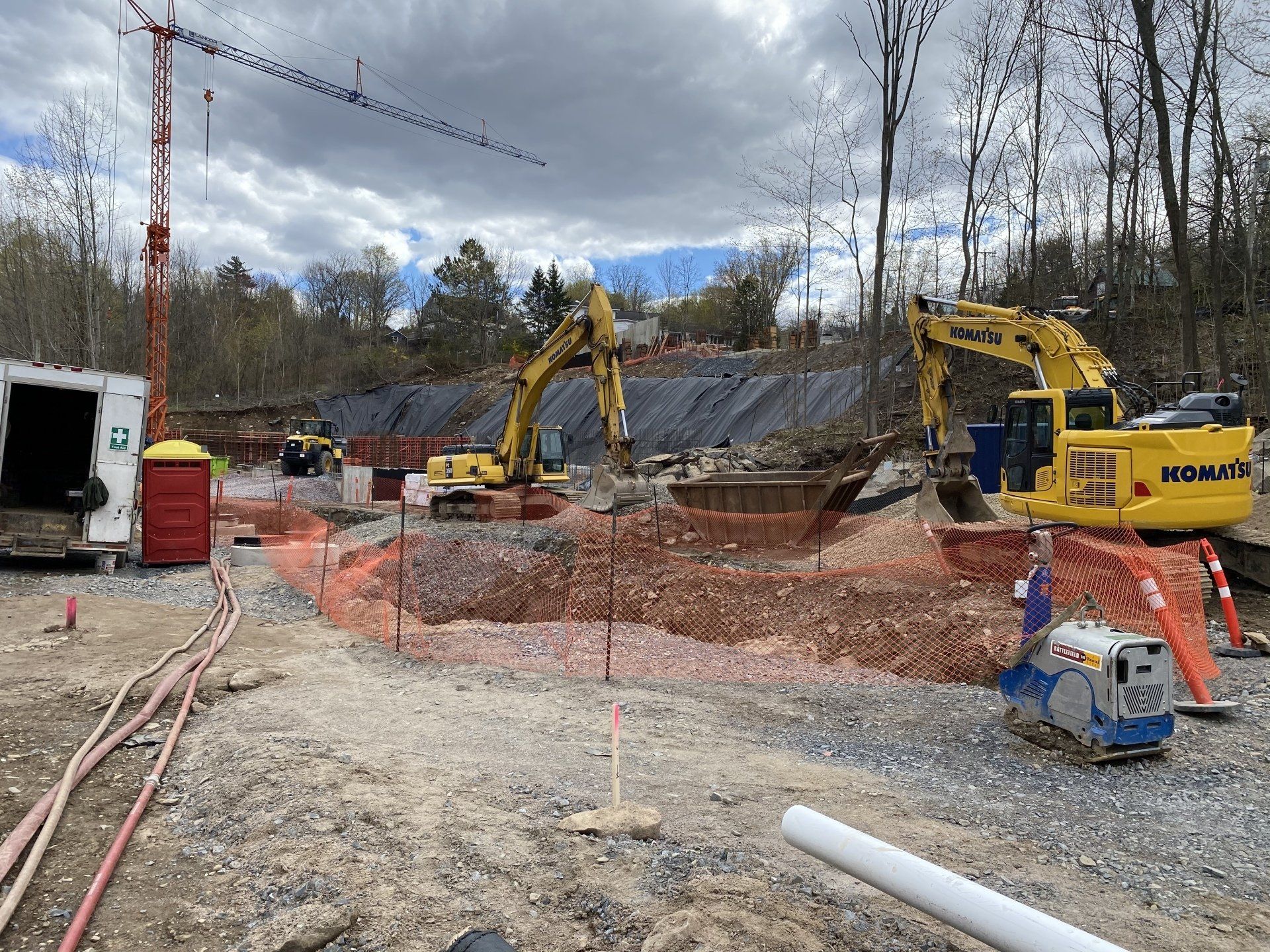 A construction site with a lot of machinery and a crane.