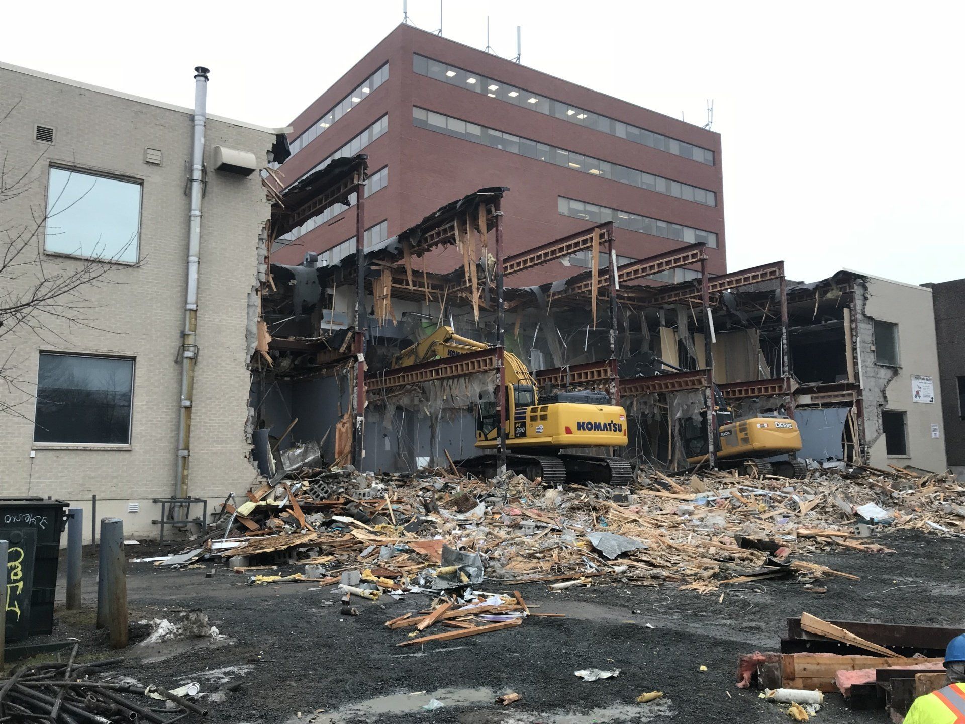 A large building is being demolished by a bulldozer.